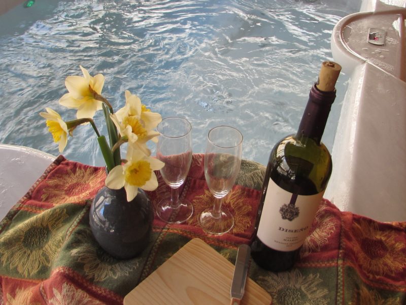 Enjoy the hot tub on the front porch of the Moondance romantic honeymoon cabin at Dancing Sun Cabins in Hot Springs, NC near Max Patch